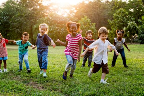 group-diverse-kids-playing-field-together