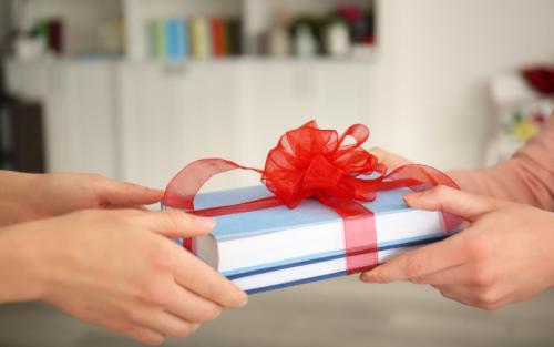 woman-giving-books-with-ribbon-as-gift (1)